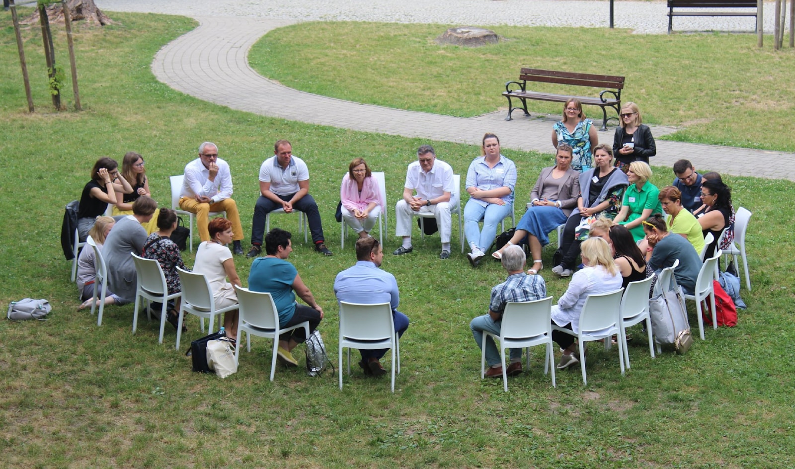 Volonté Populaire Mauritius: circle of people sitting on chair on grass fiedl