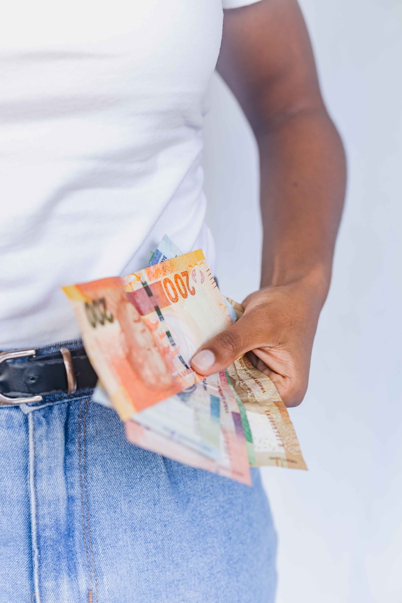 Mauritius Tax Statement: a person holding a bunch of money in their pocket