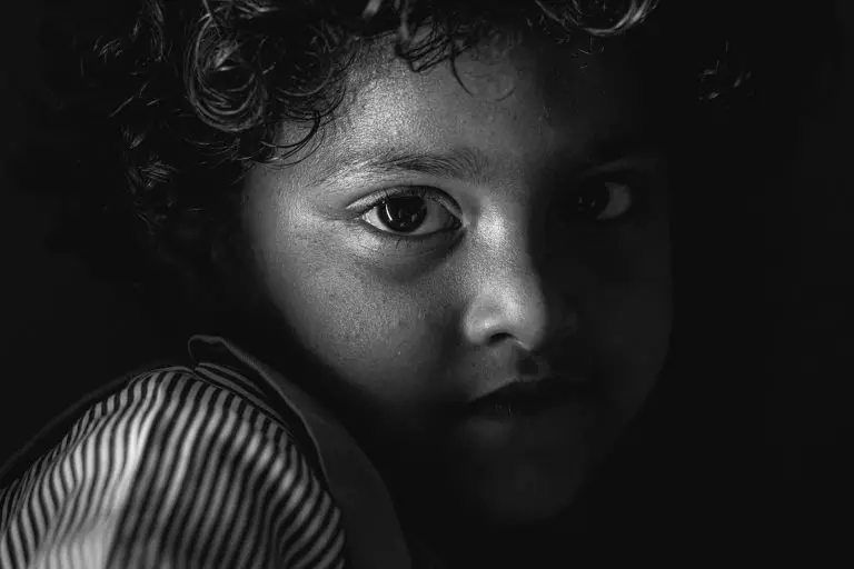 Child abuse Mauritius: a black and white photo of a child with curly hair
