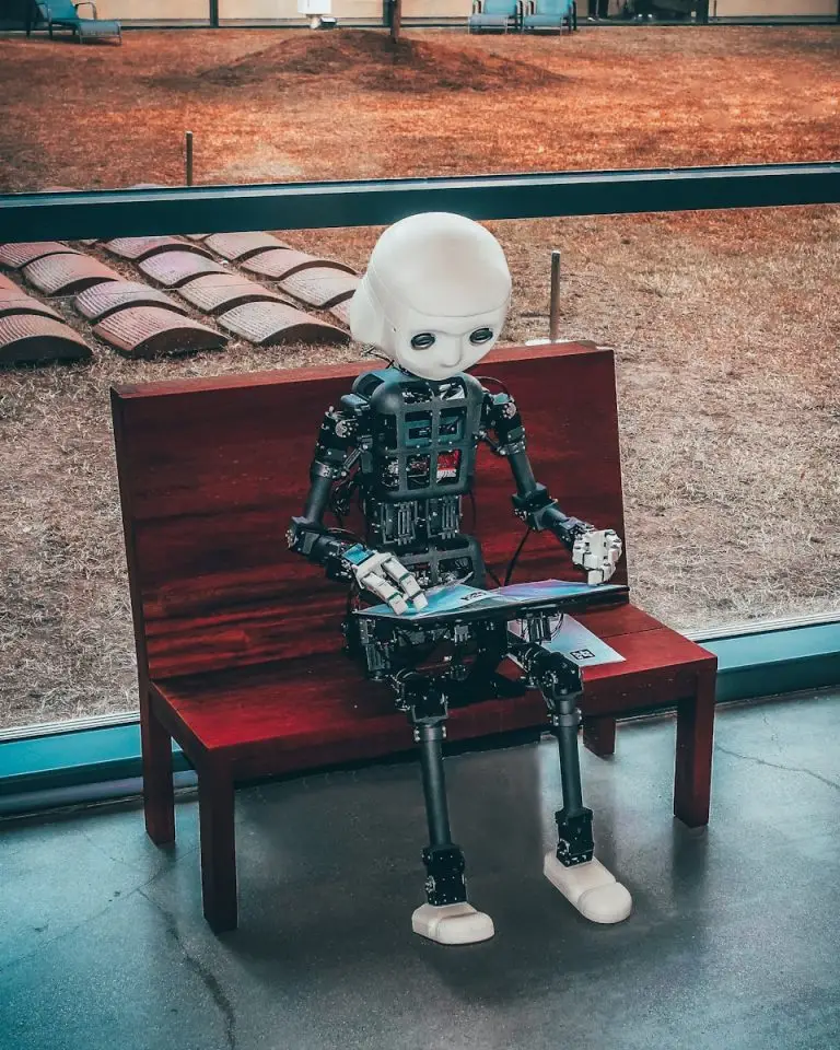 AI Digital Revolution: black and white robot toy on red wooden table