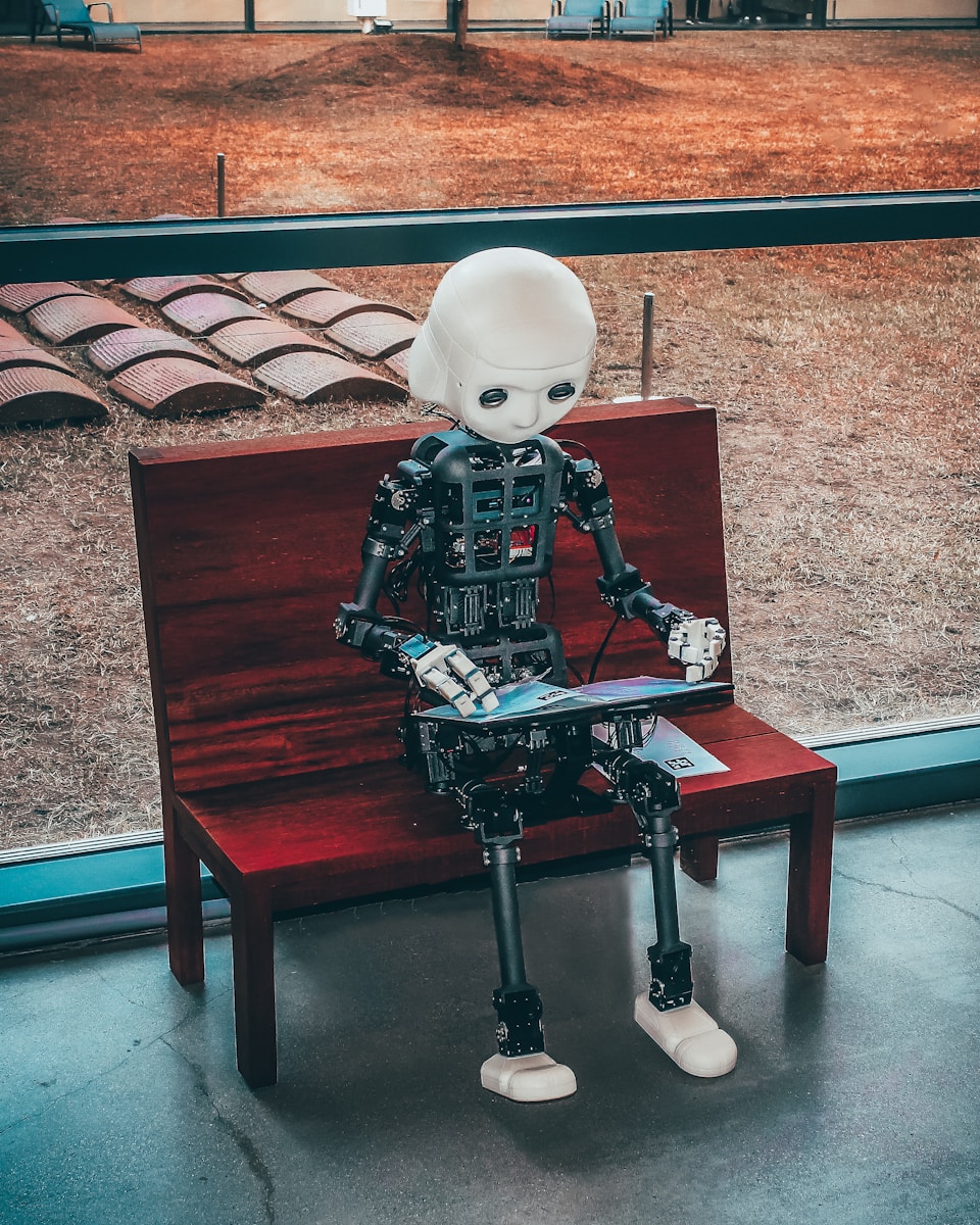 AI Digital Revolution: black and white robot toy on red wooden table