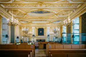 Family Court Death: Ornate courtroom with gilded decorations and chandeliers